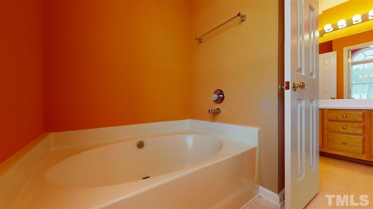 4840 Topstone Road Raleigh, NC 27603 - Photo 23 of 30 a bathroom with a tub