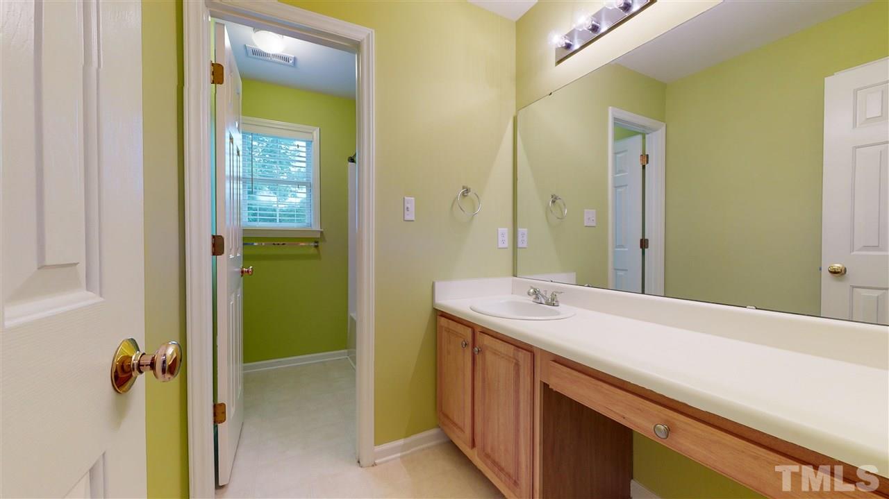 4840 Topstone Road Raleigh, NC 27603 - Photo 25 of 30 a bathroom with a sink and a mirror