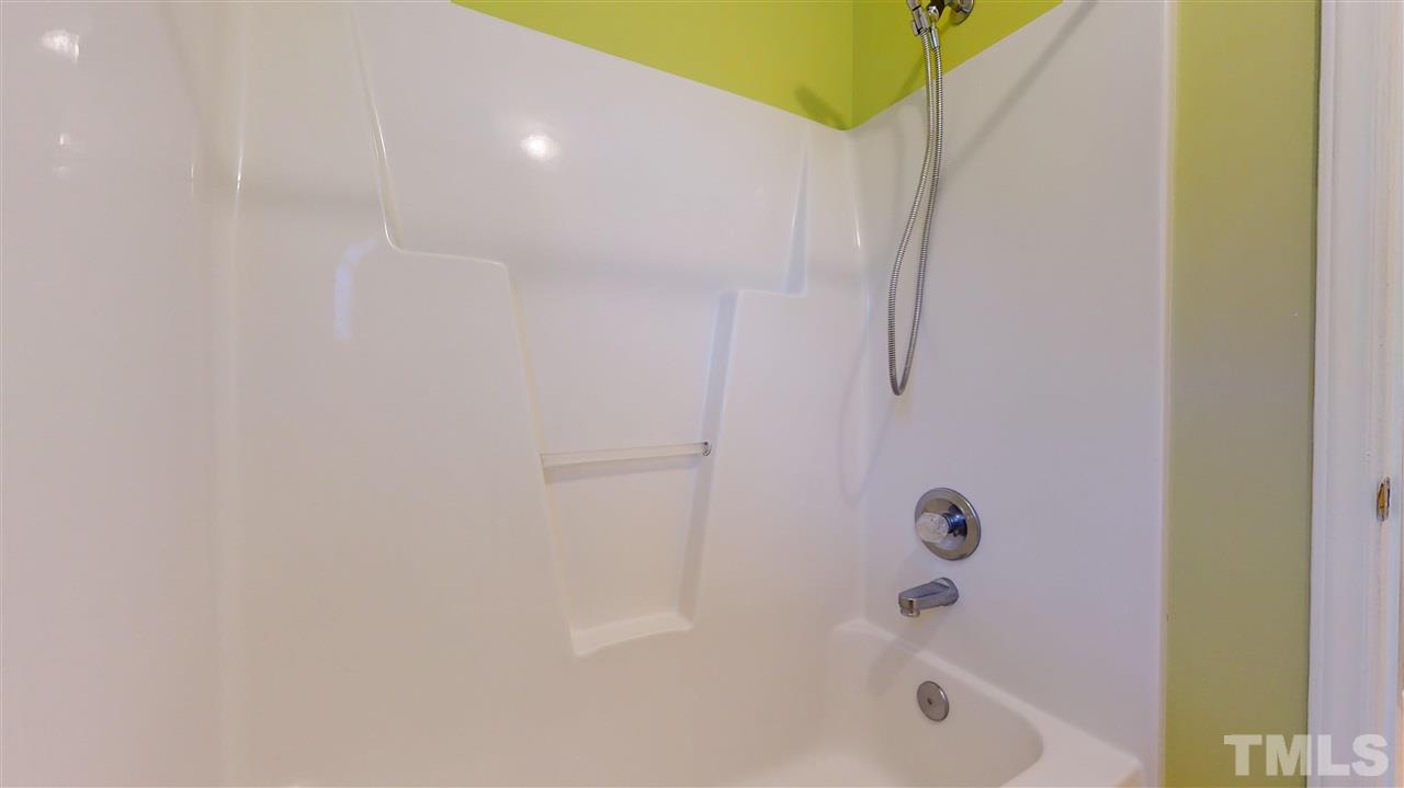 4840 Topstone Road Raleigh, NC 27603 - Photo 26 of 30 a bathroom with a bathtub