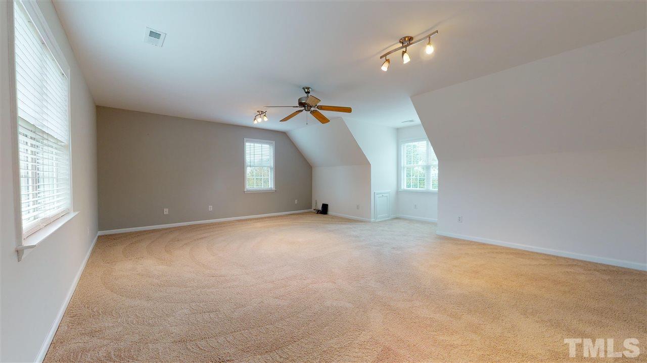 4840 Topstone Road Raleigh, NC 27603 - Photo 29 of 30 an empty room with a window and ceiling fan