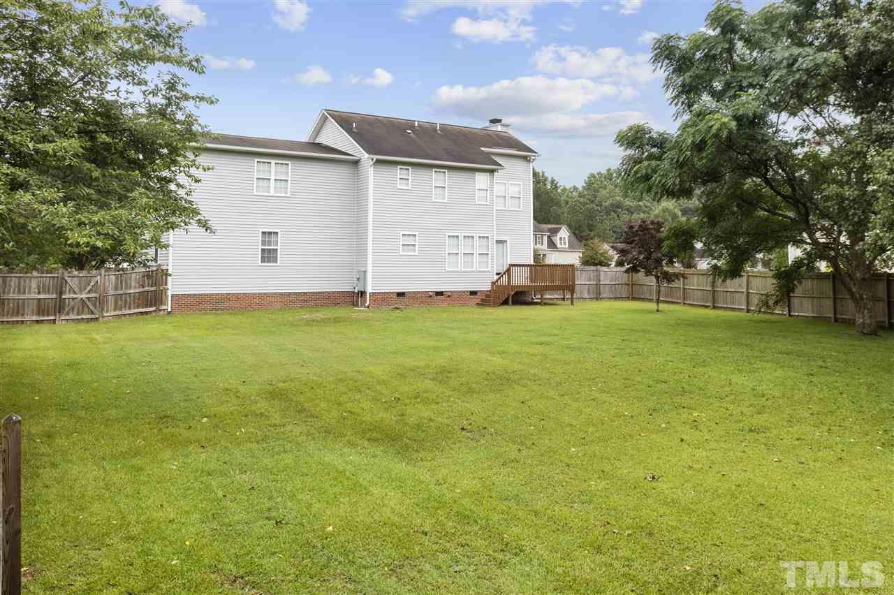 4840 Topstone Road Raleigh, NC 27603 - Photo 5 of 30 a view of a house with a big yard and large trees
