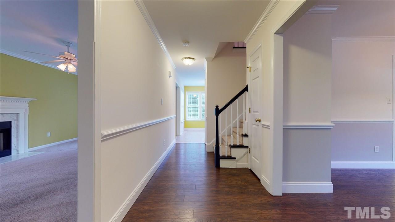 4840 Topstone Road Raleigh, NC 27603 - Photo 10 of 30 a view of entryway with stairs and wooden floor