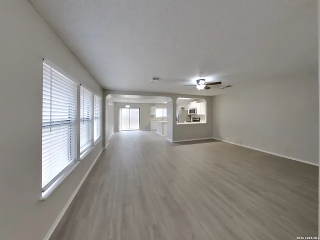 a view of wooden floor and windows in an empty room