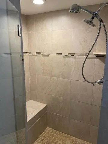 a bathroom with a shower and a sink