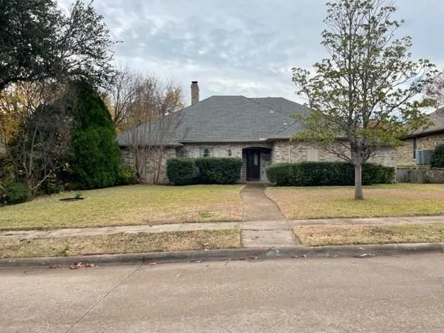 a house that has a tree in front of it