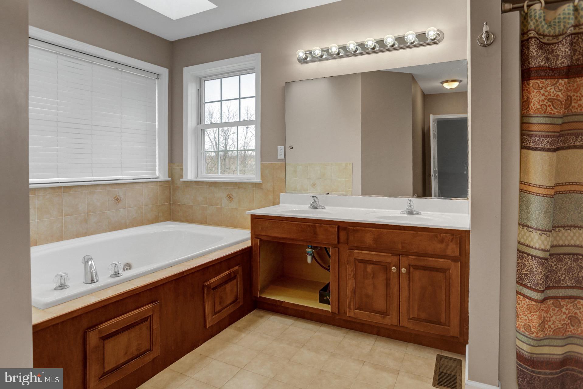 23 Pacific Avenue Reading, PA 19608 - Photo 23 of 38 a bathroom with a tub sink and mirror