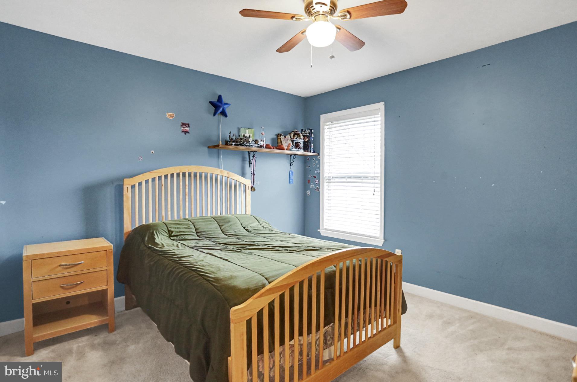 23 Pacific Avenue Reading, PA 19608 - Photo 29 of 38 a bedroom with a bed and a chandelier