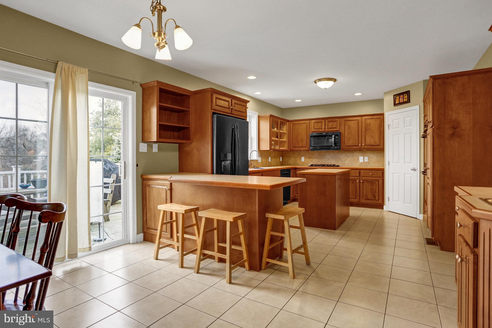 23 Pacific Avenue Reading, PA 19608 - Photo 8 of 38 a kitchen with stainless steel appliances granite countertop a refrigerator and a stove top oven