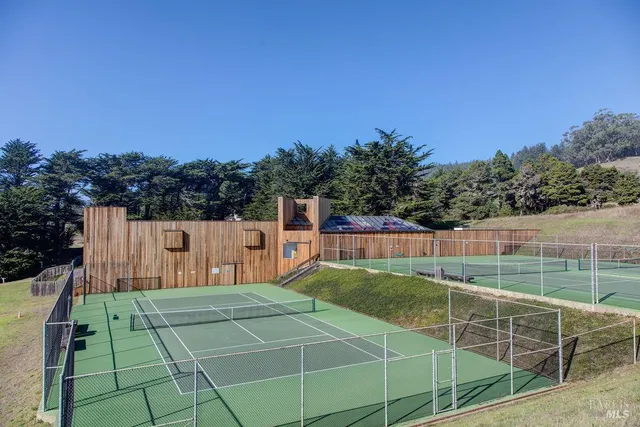 a backyard of a house with lots of green space and trees