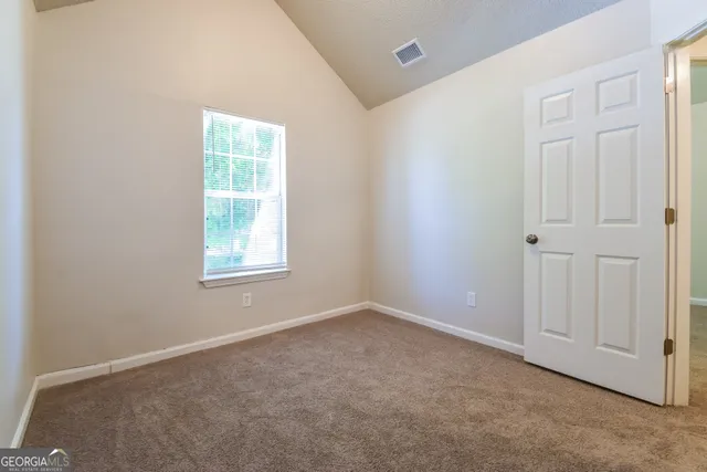 an empty room with closet area