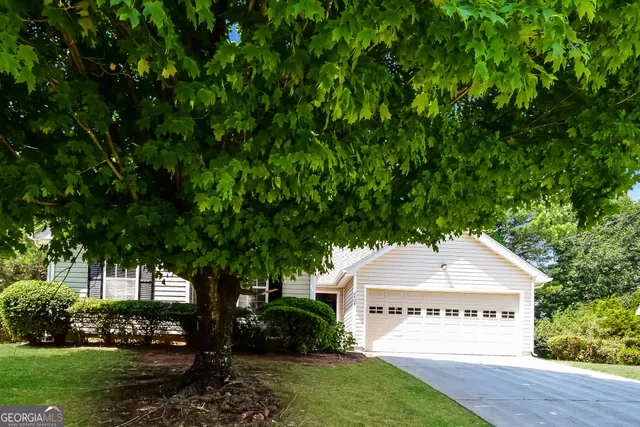 an empty room with wooden floor fireplace and windows