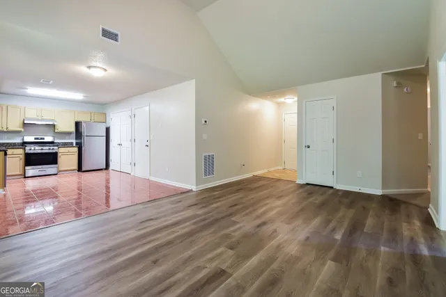 a kitchen with a refrigerator sink and cabinets