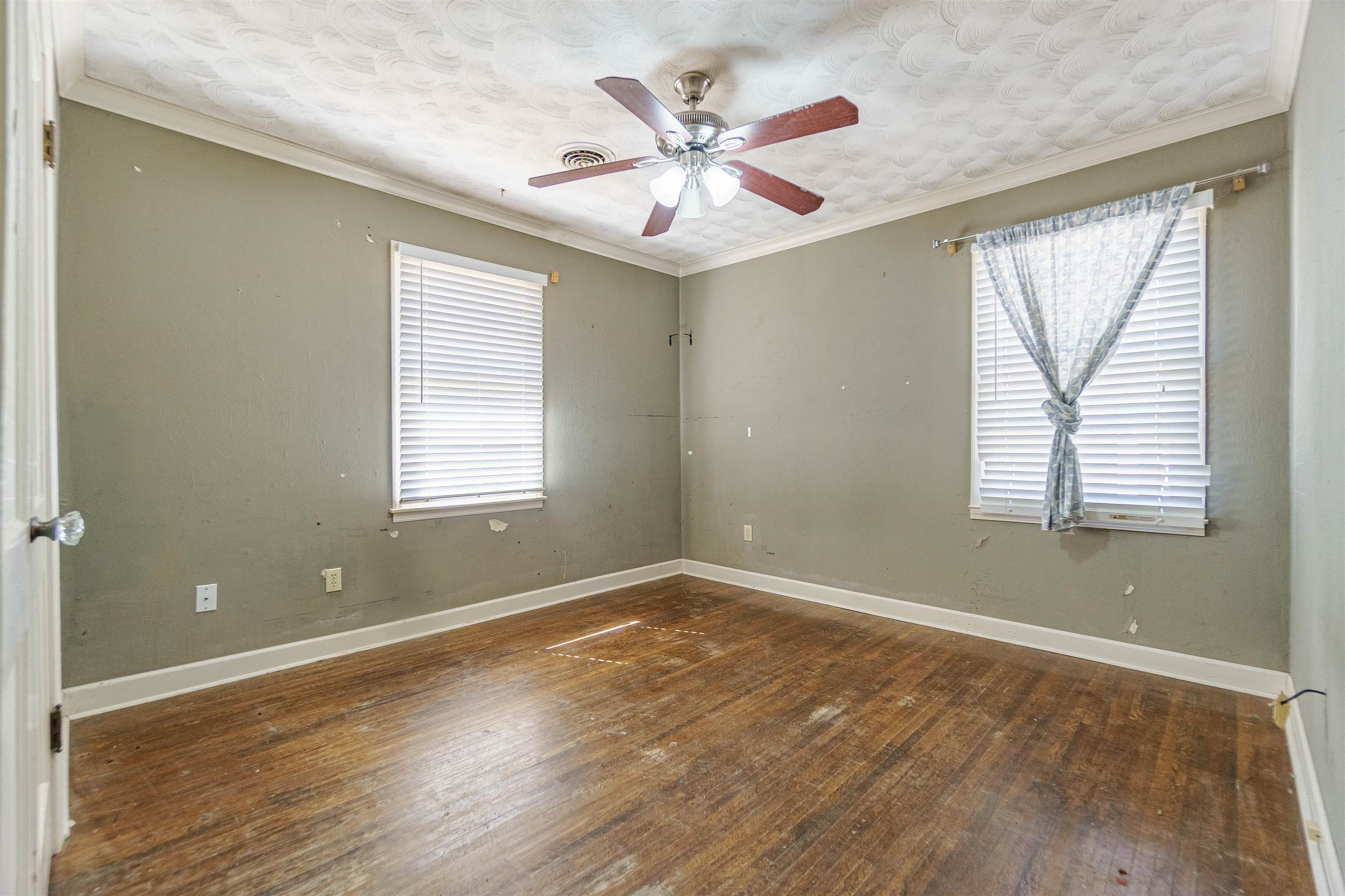4590 Monaco Road Memphis, TN 38117 - Photo 8 of 14 an empty room with wooden floor and windows