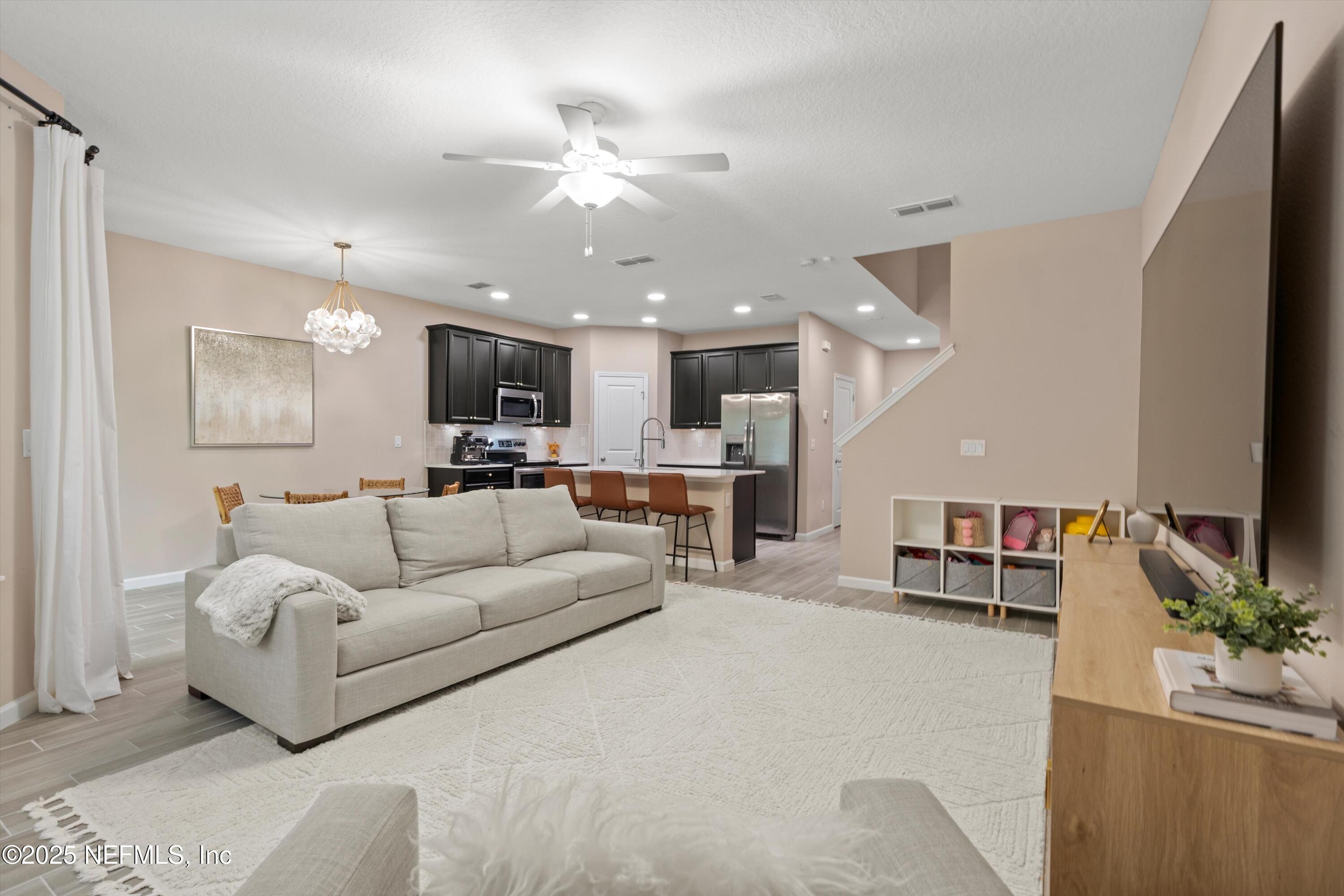 352 Boracay Circle St. Johns, FL 32259 - Photo 16 of 45 a living room with furniture and kitchen view