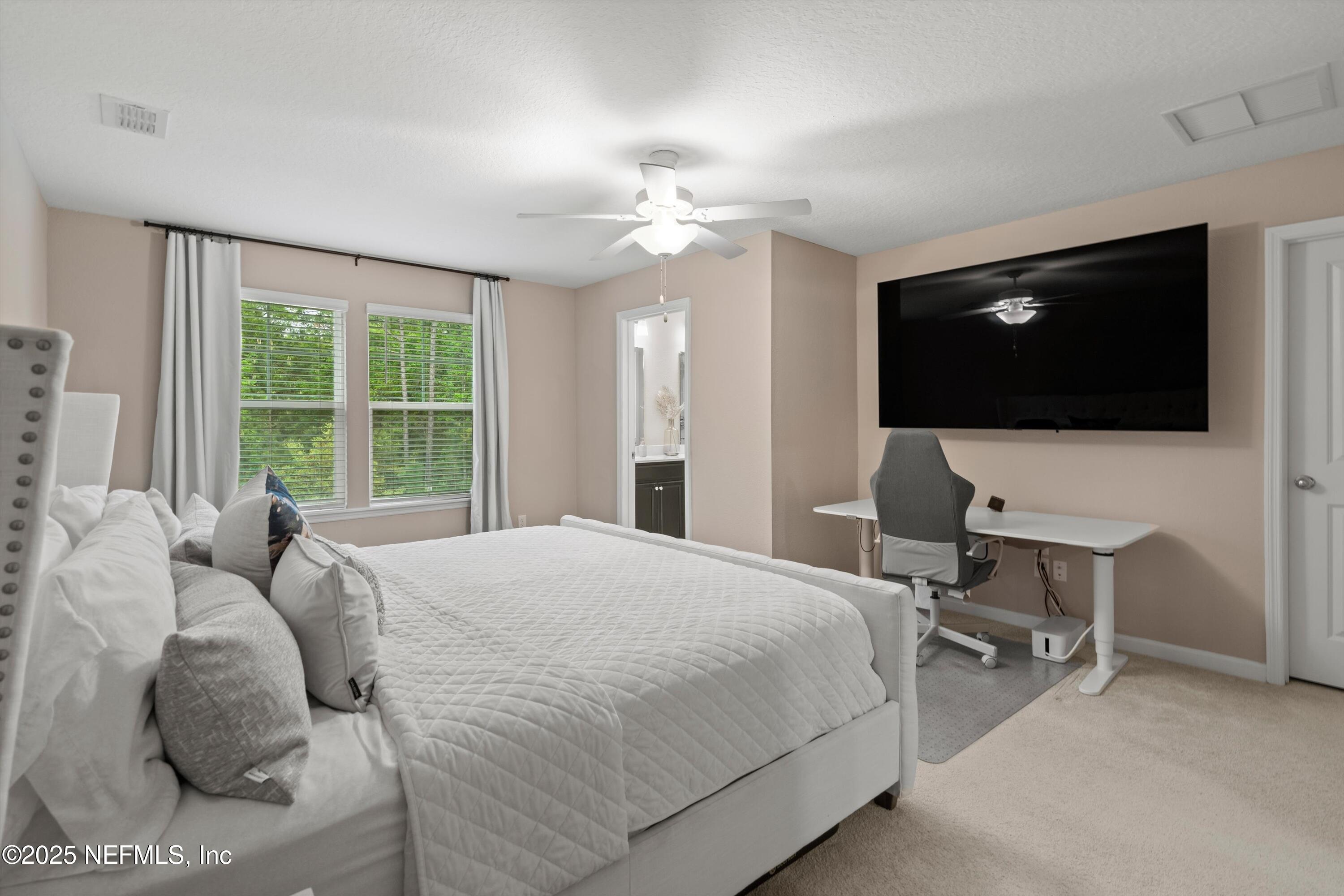 352 Boracay Circle St. Johns, FL 32259 - Photo 19 of 45 a bedroom with a large bed and a flat screen tv