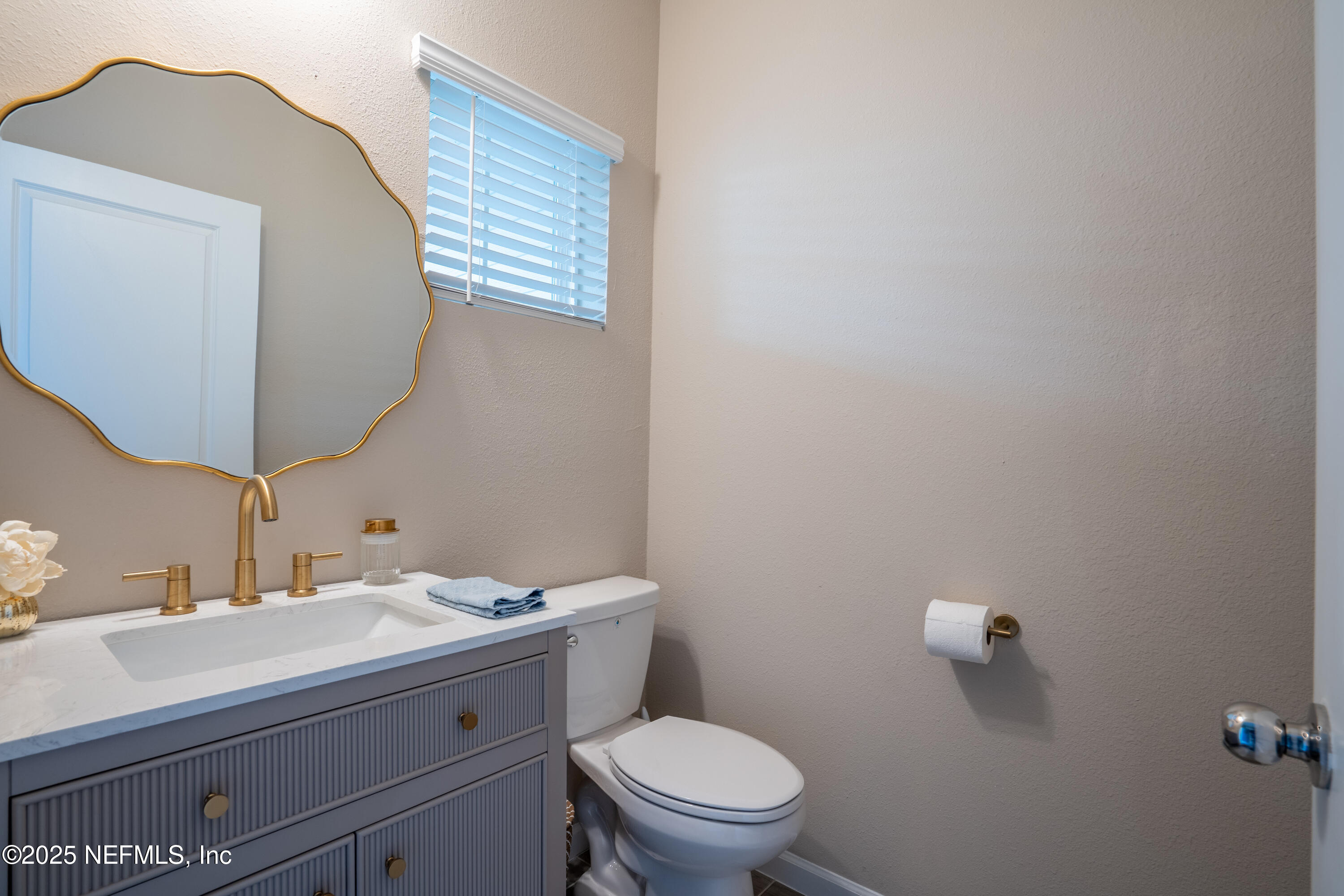 352 Boracay Circle St. Johns, FL 32259 - Photo 7 of 45 a bathroom with a granite countertop toilet a sink and mirror