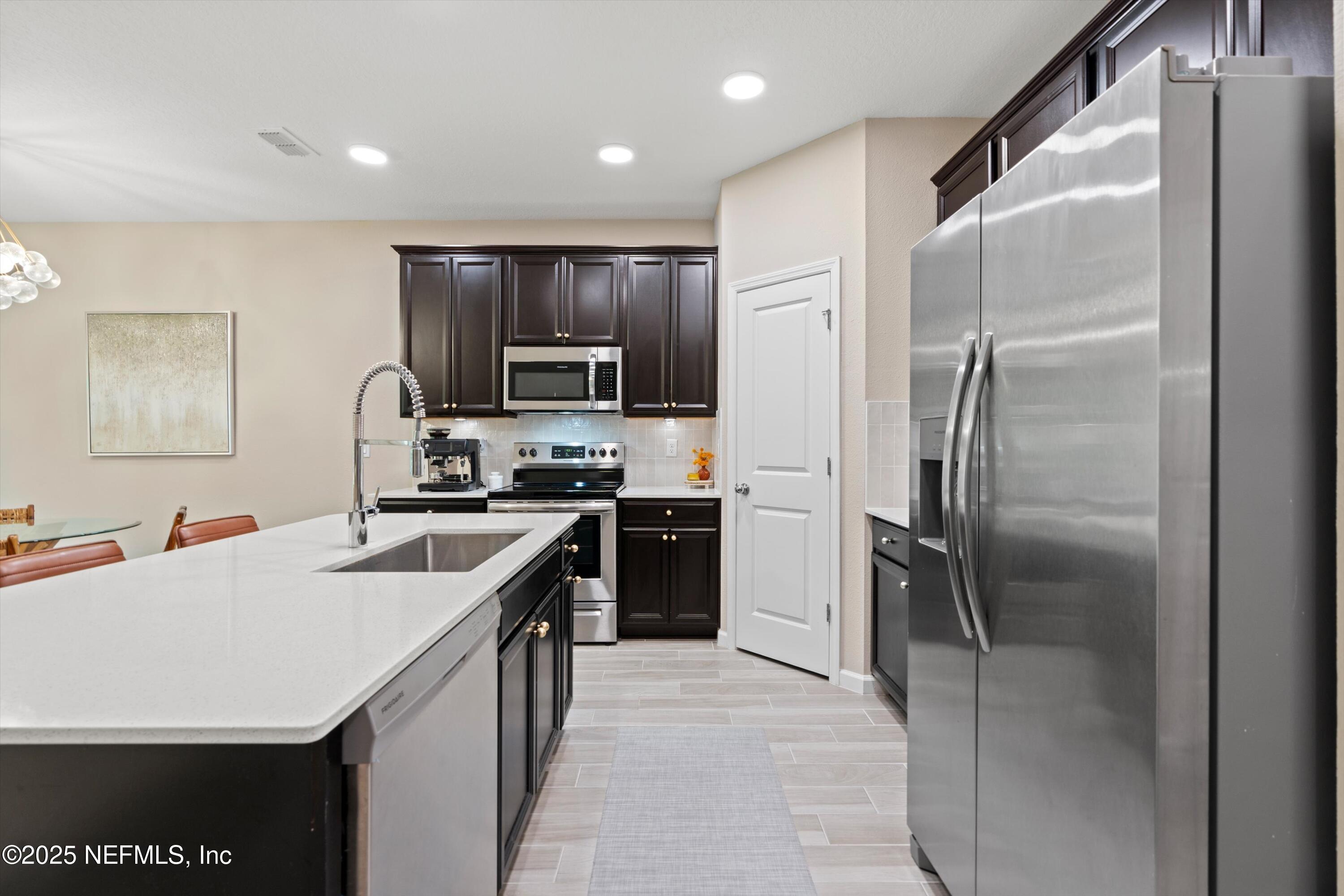 352 Boracay Circle St. Johns, FL 32259 - Photo 9 of 45 a kitchen with kitchen island a counter top space stainless steel appliances and cabinets