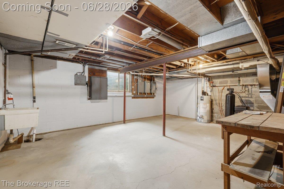 8475 Knox Road Clarkston, MI 48348 - Photo 51 of 71 Unfinished basement featuring exposed wood joists, concrete block walls, and a utility sink