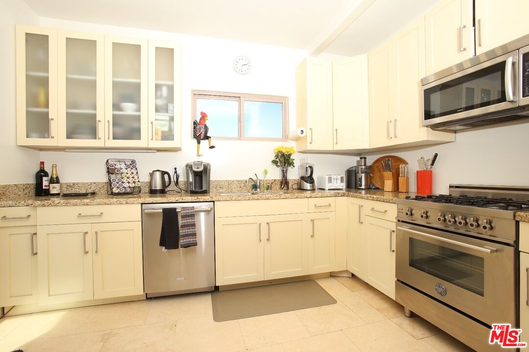 4447 Calhoun Avenue Sherman Oaks, CA 91423 - Photo 11 of 28 a kitchen with granite countertop cabinets stainless steel appliances and a sink