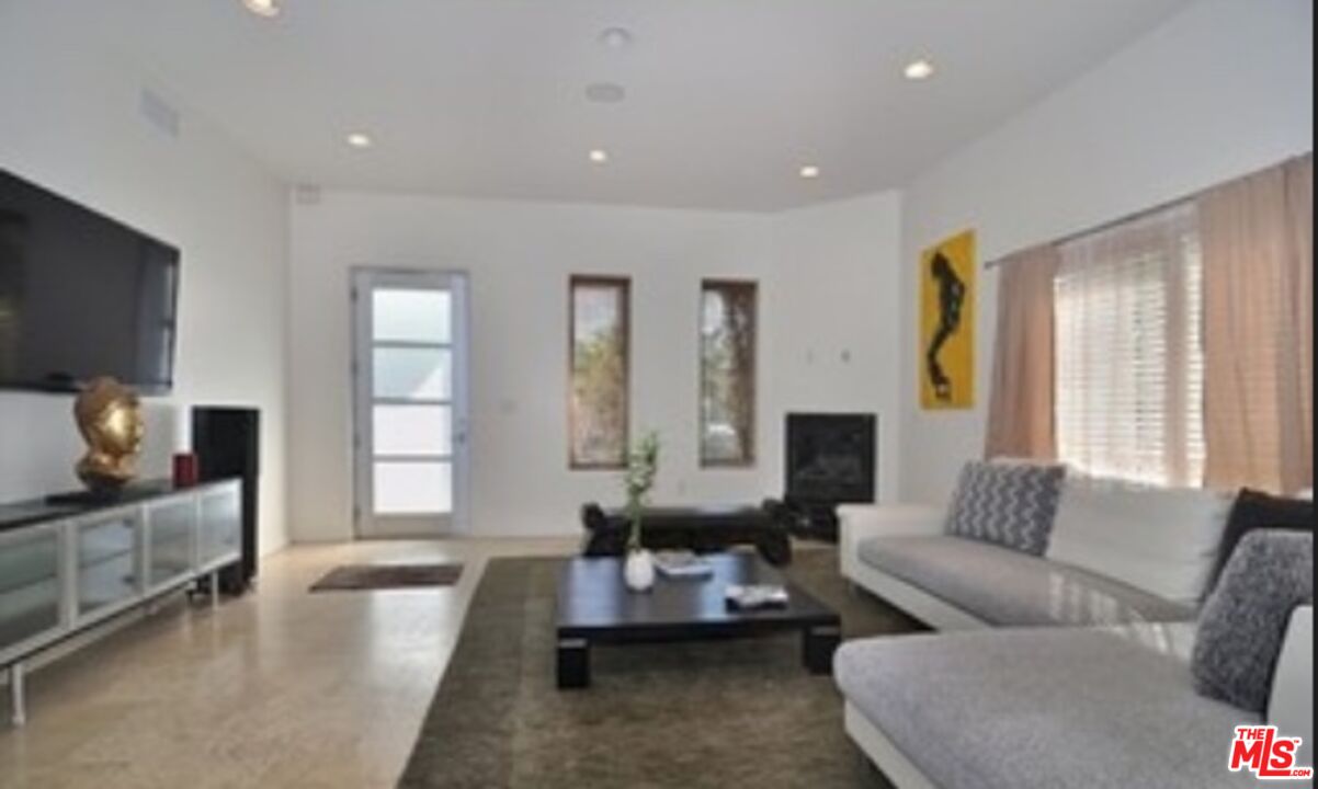 4447 Calhoun Avenue Sherman Oaks, CA 91423 - Photo 21 of 28 a living room with furniture and a flat screen tv