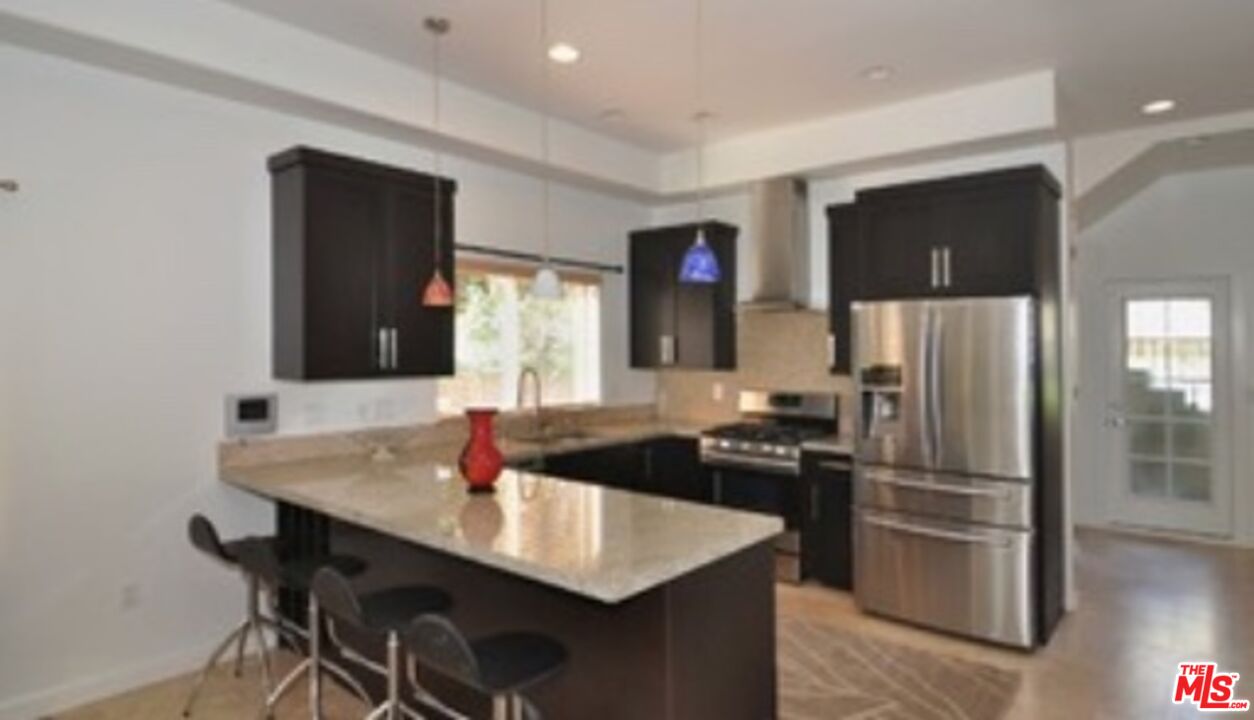 4447 Calhoun Avenue Sherman Oaks, CA 91423 - Photo 22 of 28 a kitchen with stainless steel appliances granite countertop a sink and a refrigerator