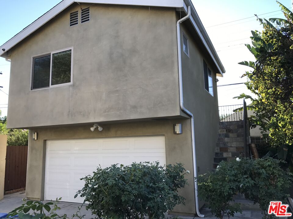 4447 Calhoun Avenue Sherman Oaks, CA 91423 - Photo 26 of 28 a house with trees in front of it