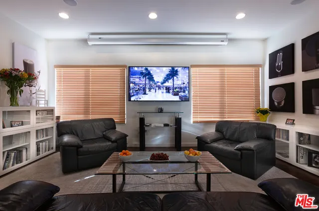 a living room with furniture flat screen tv and a fireplace