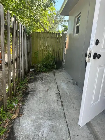 a view of a pathway with a backyard
