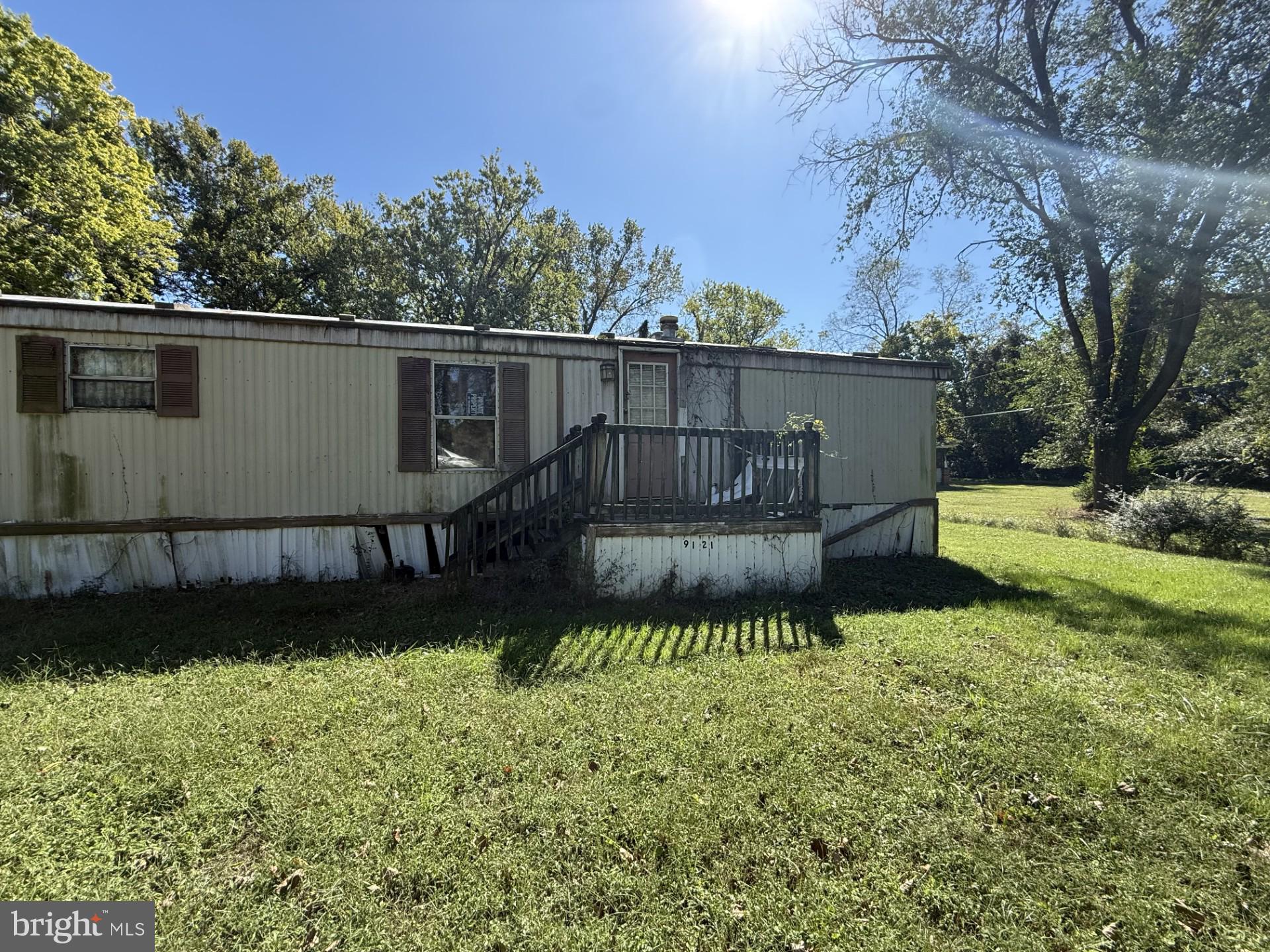 9121 Deal Island Road Deal Island, MD 21821 - Photo 2 of 12 a view of a garden with a bench in the background