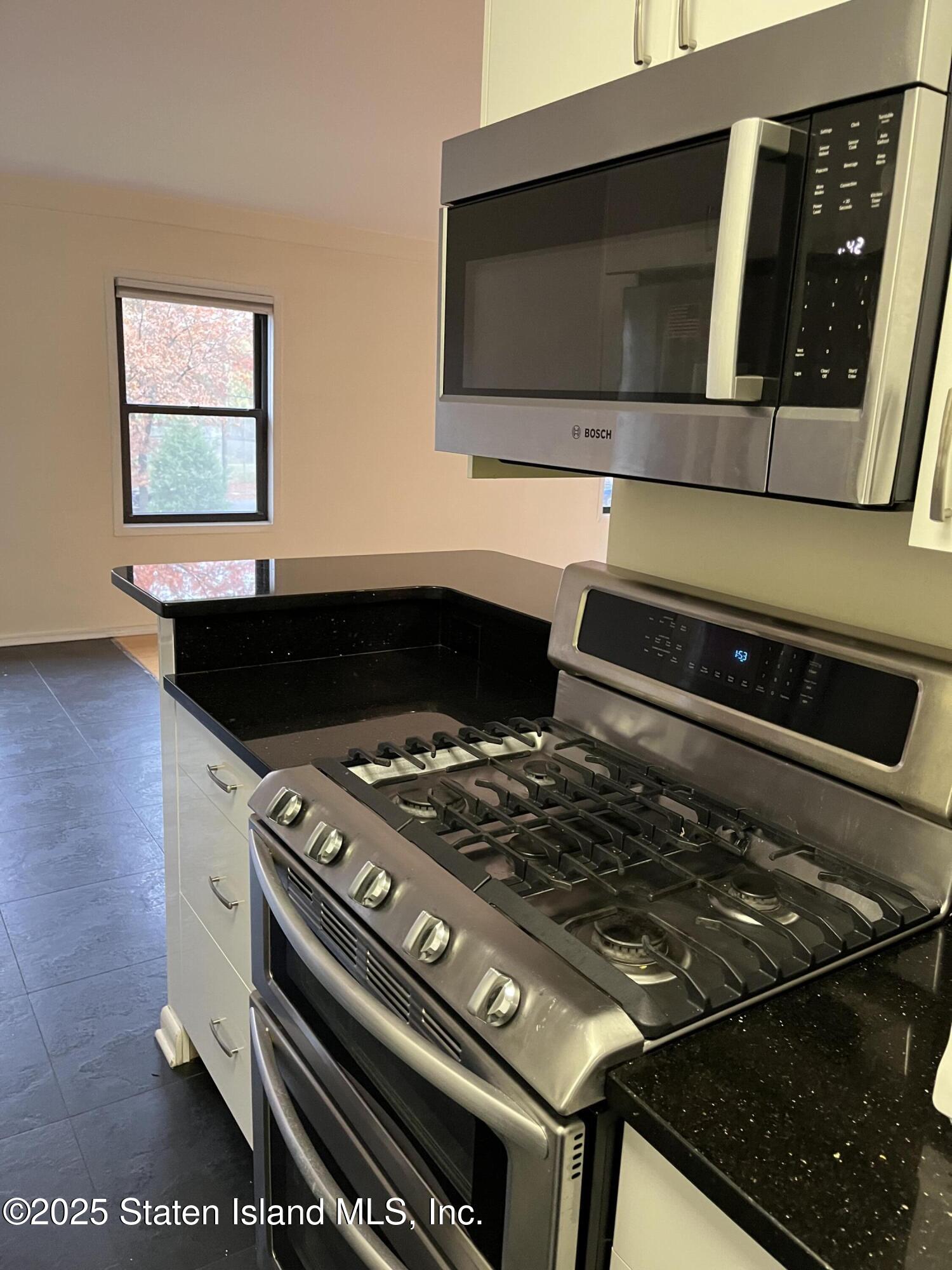 1100 Clove Road, Unit 2L Staten Island, NY 10301 - Photo 11 of 20 a stove top oven sitting inside of a kitchen
