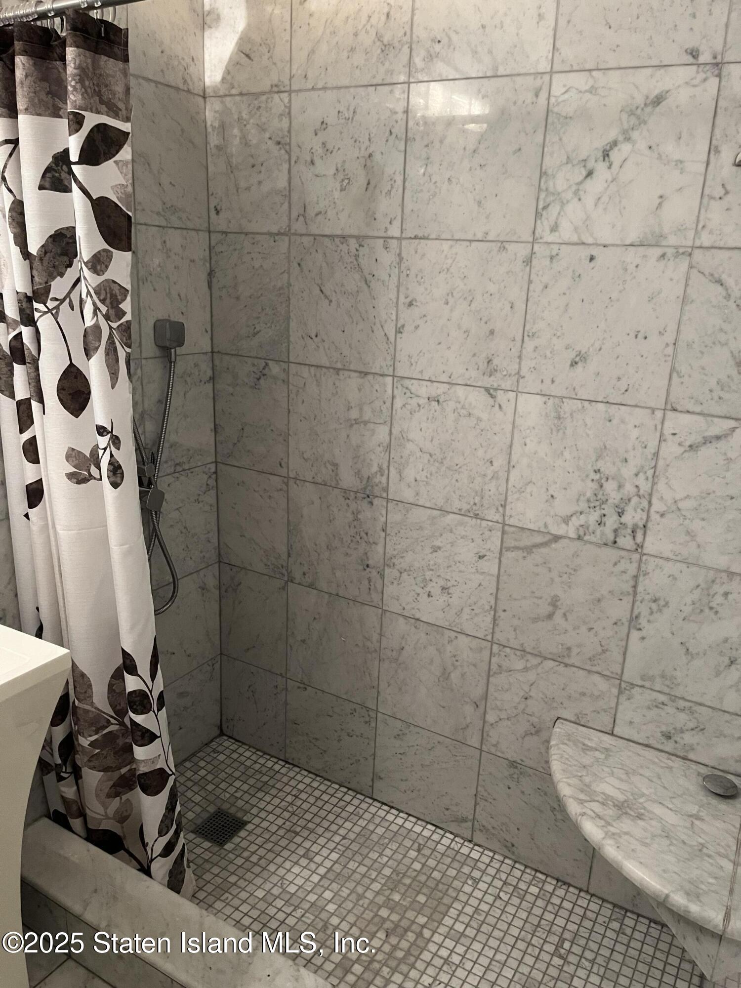 1100 Clove Road, Unit 2L Staten Island, NY 10301 - Photo 17 of 20 a bathroom with a sink a toilet and shower