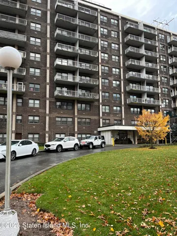 a view of a cars park in front of a building