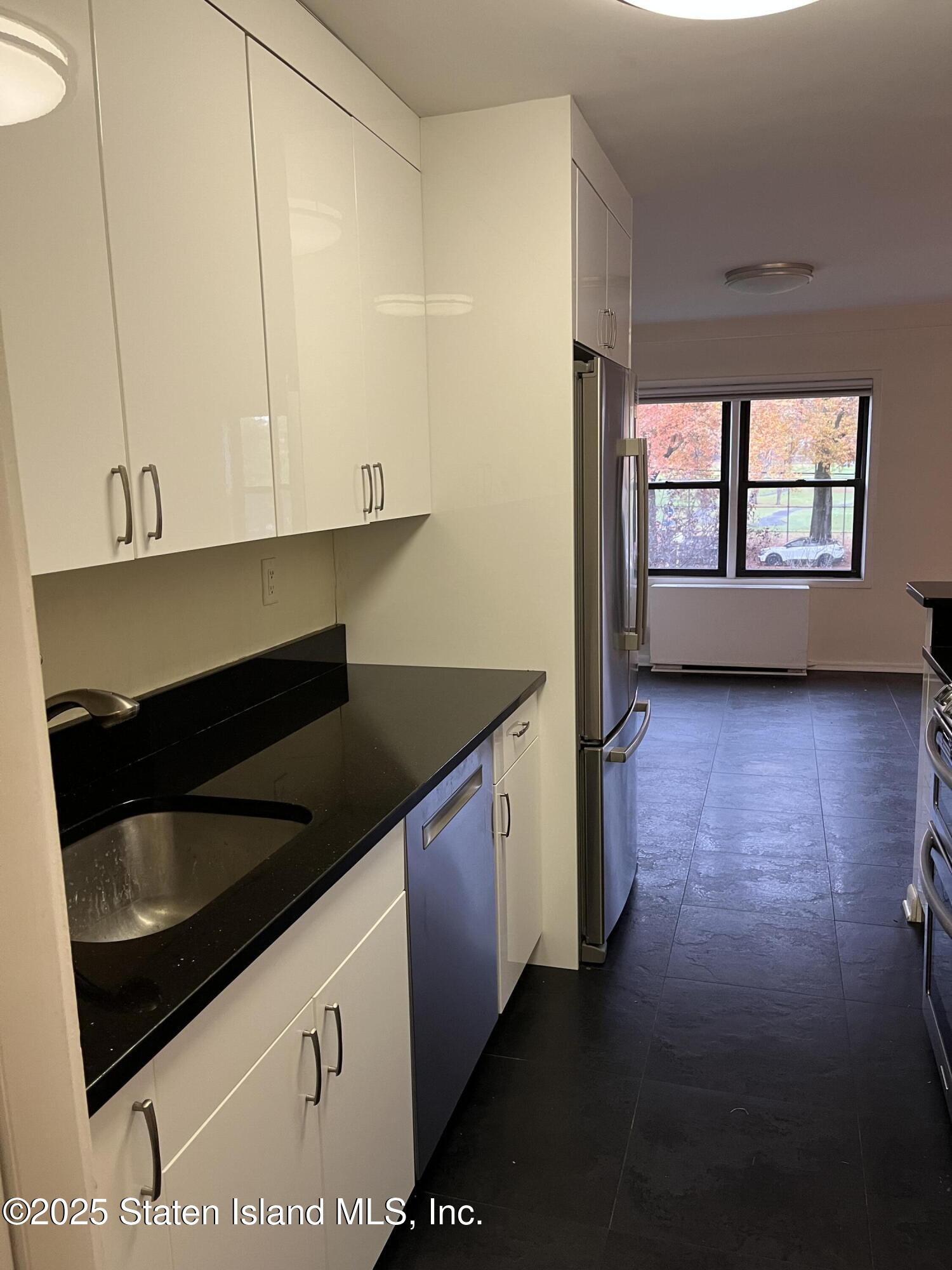 1100 Clove Road, Unit 2L Staten Island, NY 10301 - Photo 10 of 20 a kitchen with a stove and a microwave