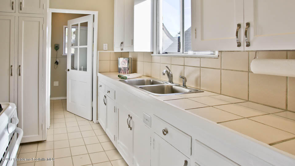 330 Fillmore Street Pasadena, CA 91106 - Photo 17 of 25 a kitchen with a sink and cabinets
