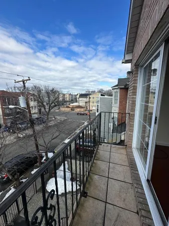a view of a balcony with an outdoor seating