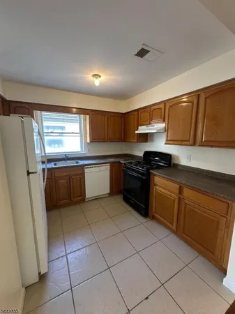 a kitchen with stainless steel appliances granite countertop a sink and cabinets