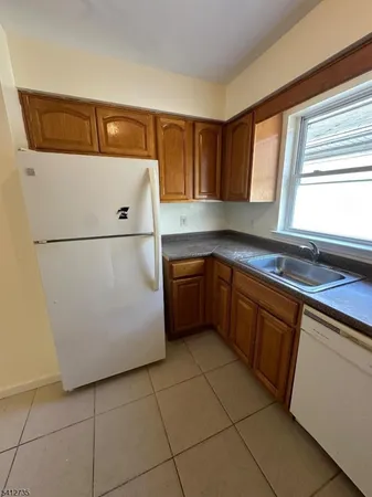 a kitchen with a cabinets and white appliances