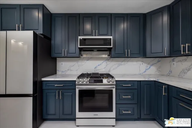a kitchen with granite countertop wooden cabinets and stainless steel appliances