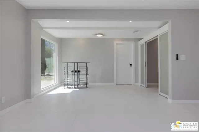 a view of an empty room with a fireplace