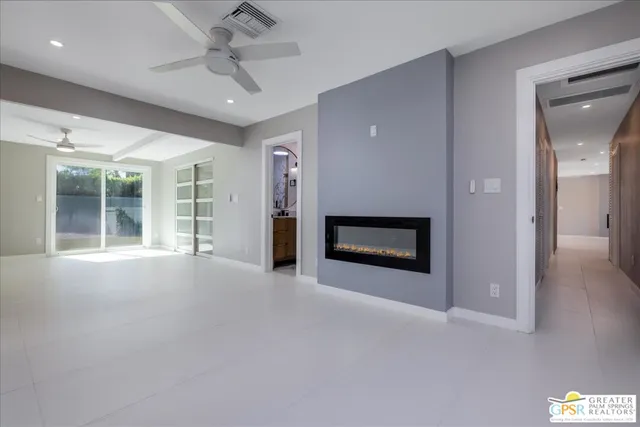 a view of a hallway with a livingroom and a fireplace