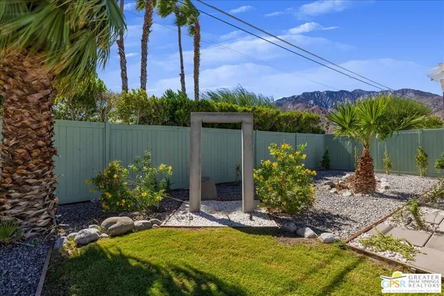 a view of swimming pool with a yard and wooden fence