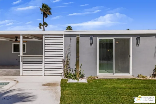 a kitchen with a stove and a wooden floor