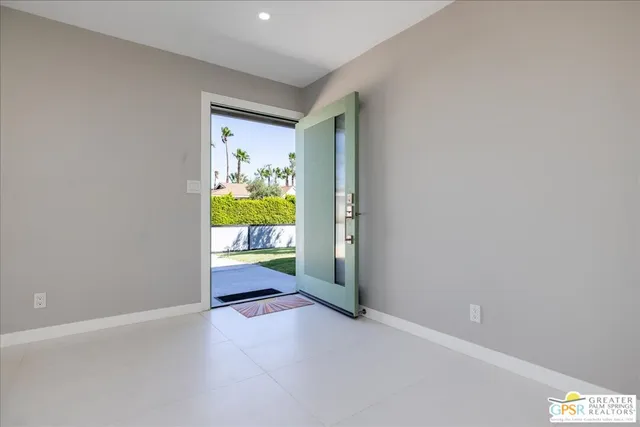 a view of an empty room and a window
