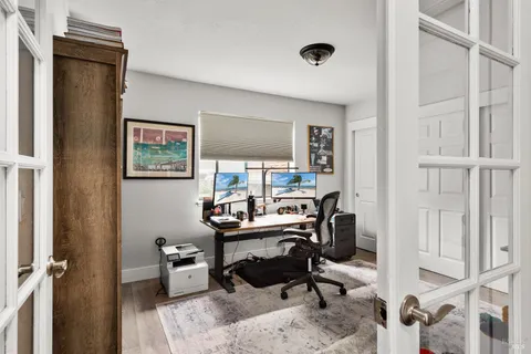 a view of a workspace with furniture and a window