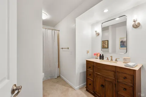 a bathroom with a double vanity sink mirror and