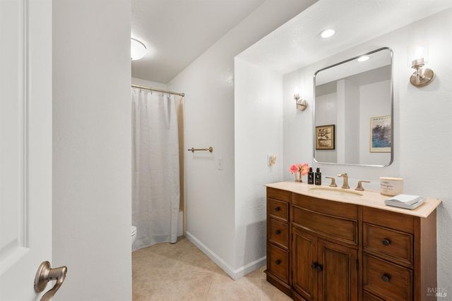 a bathroom with a double vanity sink mirror and