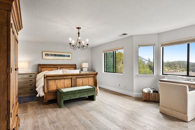 a bedroom with furniture and a window