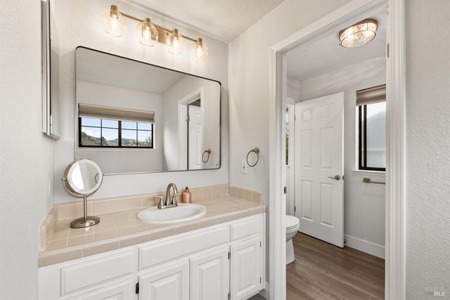 a bathroom with a sink double vanity and a mirror