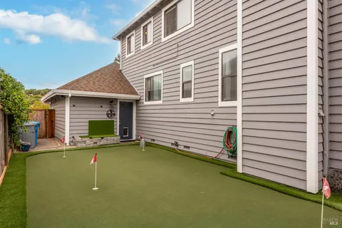 a view of a house with backyard and porch
