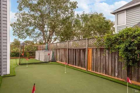 a view of swimming pool with wooden fence